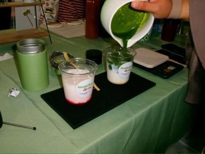 Pouring matcha to order at a setup